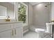 Well-lit bathroom features a white vanity, tiled shower-tub and contemporary fixtures at 731 S Missouri Ave, Lakeland, FL 33815