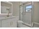 The bright bathroom features a glass shower, vanity, and a lighted mirror for optimal lighting at 731 S Missouri Ave, Lakeland, FL 33815