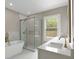Modern bathroom with a freestanding tub, glass-enclosed shower, and double vanity at 731 S Missouri Ave, Lakeland, FL 33815