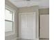 The bedroom features built-in closets with white doors, a window, and neutral walls at 731 S Missouri Ave, Lakeland, FL 33815