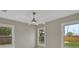 A bright bedroom with a modern ceiling fan and two windows allowing ample sunlight at 731 S Missouri Ave, Lakeland, FL 33815