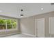 A neutral bedroom with a large window offering ample natural light and a contemporary ceiling fan at 731 S Missouri Ave, Lakeland, FL 33815
