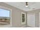 Bright bedroom with a modern ceiling fan, white trim windows, and bi-fold door closet at 731 S Missouri Ave, Lakeland, FL 33815