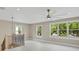 This bonus room features three windows, light-colored floors, and a ceiling fan at 731 S Missouri Ave, Lakeland, FL 33815