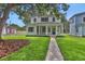 Charming two-story home with a welcoming front porch and meticulously manicured lawn at 731 S Missouri Ave, Lakeland, FL 33815