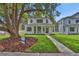 Beautiful two-story home featuring a covered porch and lush front yard with mature trees at 731 S Missouri Ave, Lakeland, FL 33815