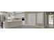 A modern, open-concept kitchen with white cabinets, a large island, and stainless steel appliances at 731 S Missouri Ave, Lakeland, FL 33815
