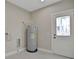 The laundry room features a hot water tank, a windowed door, and a dryer hookup at 731 S Missouri Ave, Lakeland, FL 33815