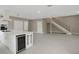 Spacious living area with an island kitchen, a wine cooler and a staircase in the background at 731 S Missouri Ave, Lakeland, FL 33815