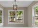 Bright living room with large windows offering abundant natural light and modern lighting fixture at 731 S Missouri Ave, Lakeland, FL 33815