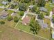 Aerial view of the home surrounded by mature trees, landscaped yard, and neighborhood at 7932 Ridge Pointe W Dr, Lakeland, FL 33810