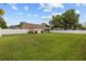Expansive backyard with a pristine lawn, a white fence, and rear home elevation at 7932 Ridge Pointe W Dr, Lakeland, FL 33810