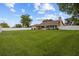 Spacious backyard with lush green grass, a white fence, and an enclosed lanai at 7932 Ridge Pointe W Dr, Lakeland, FL 33810