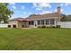 The backyard has a white fence, patio and an enclosed lanai with manicured landscaping at 7932 Ridge Pointe W Dr, Lakeland, FL 33810
