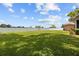 Open green backyard enclosed with white fencing, perfect for entertaining and play at 7932 Ridge Pointe W Dr, Lakeland, FL 33810