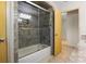 Bathroom with tiled shower and sliding glass door at 7932 Ridge Pointe W Dr, Lakeland, FL 33810