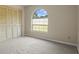 Bedroom featuring neutral paint, neutral carpet, and modern windows at 7932 Ridge Pointe W Dr, Lakeland, FL 33810