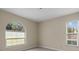 Bedroom featuring neutral paint, neutral carpet, and modern windows at 7932 Ridge Pointe W Dr, Lakeland, FL 33810