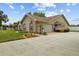 An eye-level view of a home's exterior showcasing its design and well-kept landscaping at 7932 Ridge Pointe W Dr, Lakeland, FL 33810
