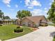 Lush lawn and landscaping accent the home's exterior, creating curb appeal at 7932 Ridge Pointe W Dr, Lakeland, FL 33810