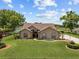 Charming single-story home featuring a well-manicured lawn and mature trees in a peaceful setting at 7932 Ridge Pointe W Dr, Lakeland, FL 33810
