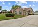 Well-manicured lawn and landscaping complement the front exterior of this inviting home at 7932 Ridge Pointe W Dr, Lakeland, FL 33810