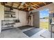 Garage with shelving, work space, open ceiling, and access to the outdoors at 7932 Ridge Pointe W Dr, Lakeland, FL 33810