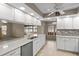 Bright kitchen featuring stainless steel appliances, white cabinetry, and quartz countertops at 7932 Ridge Pointe W Dr, Lakeland, FL 33810