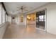 Enclosed lanai with tile floors, windows, and view of the kitchen at 7932 Ridge Pointe W Dr, Lakeland, FL 33810