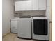 Laundry room with full size washer and dryer, and white cabinets at 7932 Ridge Pointe W Dr, Lakeland, FL 33810