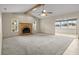 Expansive living room featuring vaulted ceilings, brick fireplace, and access to a sunroom at 7932 Ridge Pointe W Dr, Lakeland, FL 33810