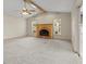 Spacious living room featuring vaulted ceilings, a brick fireplace, and access to the outdoors at 7932 Ridge Pointe W Dr, Lakeland, FL 33810