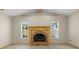 Comfortable living room featuring vaulted ceilings and a cozy brick fireplace at 7932 Ridge Pointe W Dr, Lakeland, FL 33810