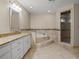 The main bathroom features a long vanity, soaking tub, and a glass shower at 7932 Ridge Pointe W Dr, Lakeland, FL 33810