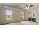The carpeted main bedroom has a ceiling fan, two windows, and access to a spa at 7932 Ridge Pointe W Dr, Lakeland, FL 33810