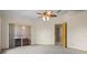 The carpeted main bedroom has a ceiling fan and access to a spa and bathroom at 7932 Ridge Pointe W Dr, Lakeland, FL 33810