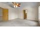 The carpeted main bedroom features a ceiling fan and an adjoining bathroom at 7932 Ridge Pointe W Dr, Lakeland, FL 33810