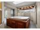 The enclosed spa room has a wooden hot tub, a skylight, and many windows at 7932 Ridge Pointe W Dr, Lakeland, FL 33810