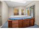 The enclosed spa room has a wooden hot tub, recessed lights, and sliding glass doors at 7932 Ridge Pointe W Dr, Lakeland, FL 33810