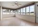 Inviting sunroom featuring a ceiling fan and large windows that let in plenty of sunlight at 7932 Ridge Pointe W Dr, Lakeland, FL 33810