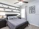 Gamer-themed bedroom with gray walls, a black bed frame, gaming art, and soft gray curtains at 867 Cypress Creek Run, St Cloud, FL 34771