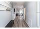 Hallway with wood floors, white trim and decor, leading to a living area with furniture at 867 Cypress Creek Run, St Cloud, FL 34771