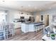 Bright kitchen with white cabinets, granite countertops, and stainless steel appliances, open to dining and living areas at 867 Cypress Creek Run, St Cloud, FL 34771