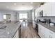 Modern kitchen with granite countertops, stainless steel appliances, and a view into the dining area at 867 Cypress Creek Run, St Cloud, FL 34771