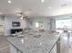 Open concept kitchen island with granite countertops, view of living and dining areas, and ample space for entertaining at 867 Cypress Creek Run, St Cloud, FL 34771