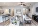 Inviting living room featuring open layout, modern furnishings, and hardwood floors; kitchen and dining nearby at 867 Cypress Creek Run, St Cloud, FL 34771