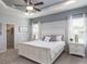 This is me HOME sign sits above a bed with a white frame, soft gray walls, and a ceiling fan at 867 Cypress Creek Run, St Cloud, FL 34771