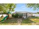 Home's backyard, featuring a play set, patio, and lush landscaping at 8904 Pebblebrooke Dr, Lakeland, FL 33810
