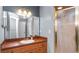 Well-lit bathroom with a large mirror, wood cabinets, and a shower at 8904 Pebblebrooke Dr, Lakeland, FL 33810