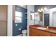 Bathroom featuring a toilet, sink with a mirror and lighting, and storage shelves at 8904 Pebblebrooke Dr, Lakeland, FL 33810
